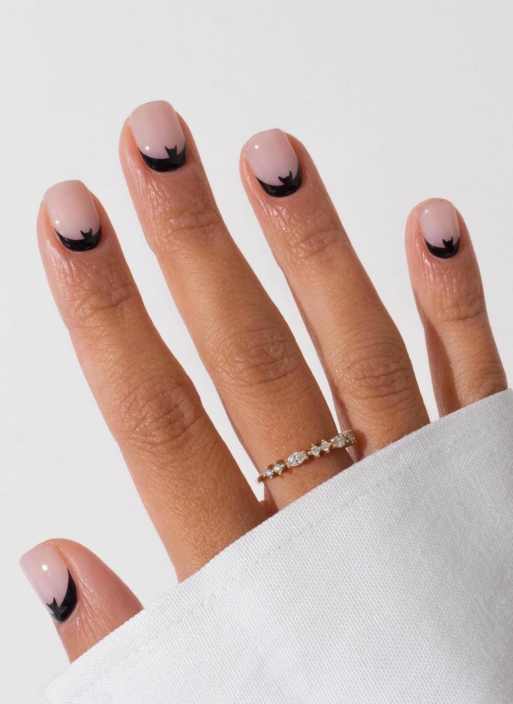 short glossy nude nails with peek-a-boo bat art