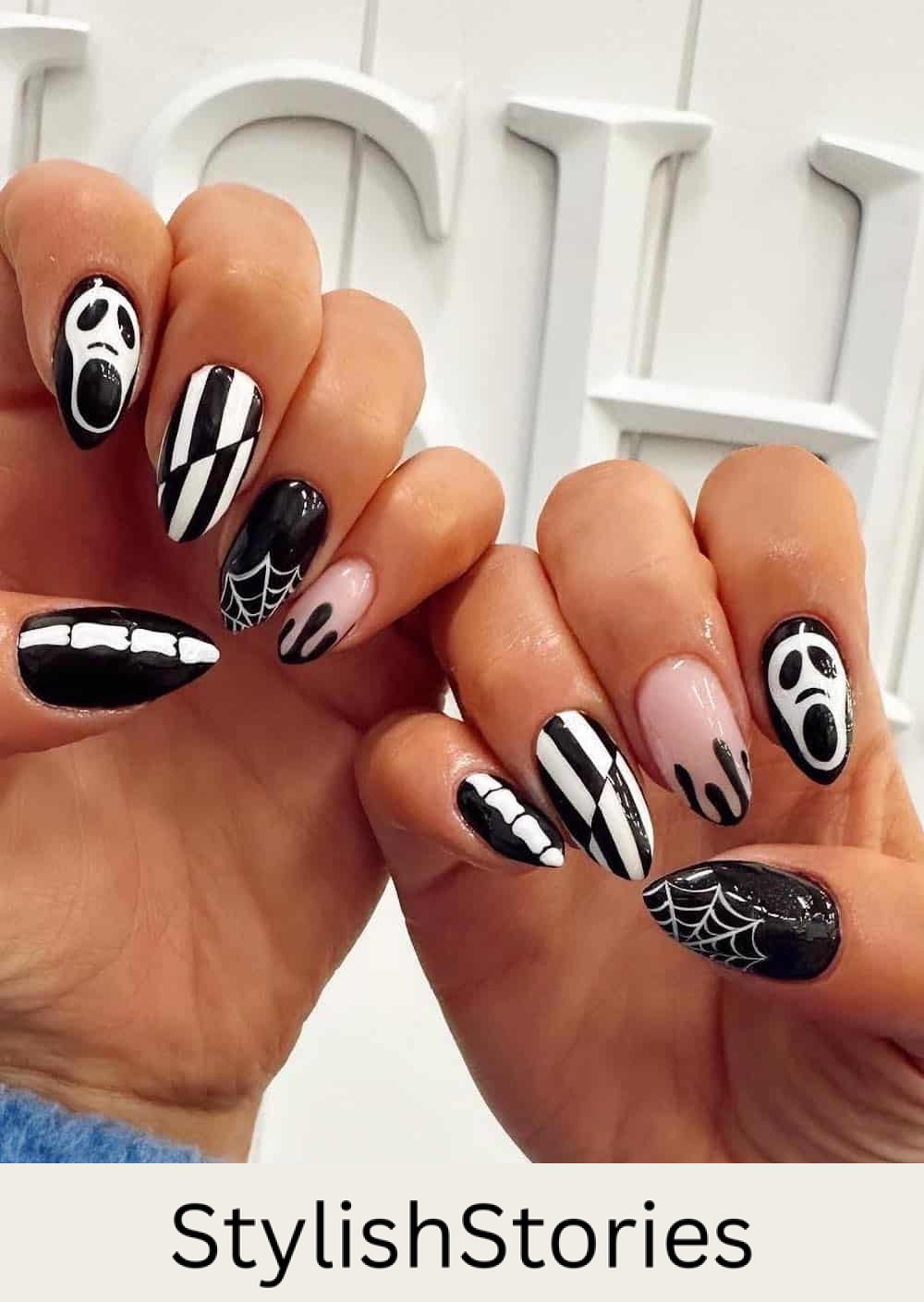 long black and white nails with Halloween nail art like Ghostface, spider webs, and bones