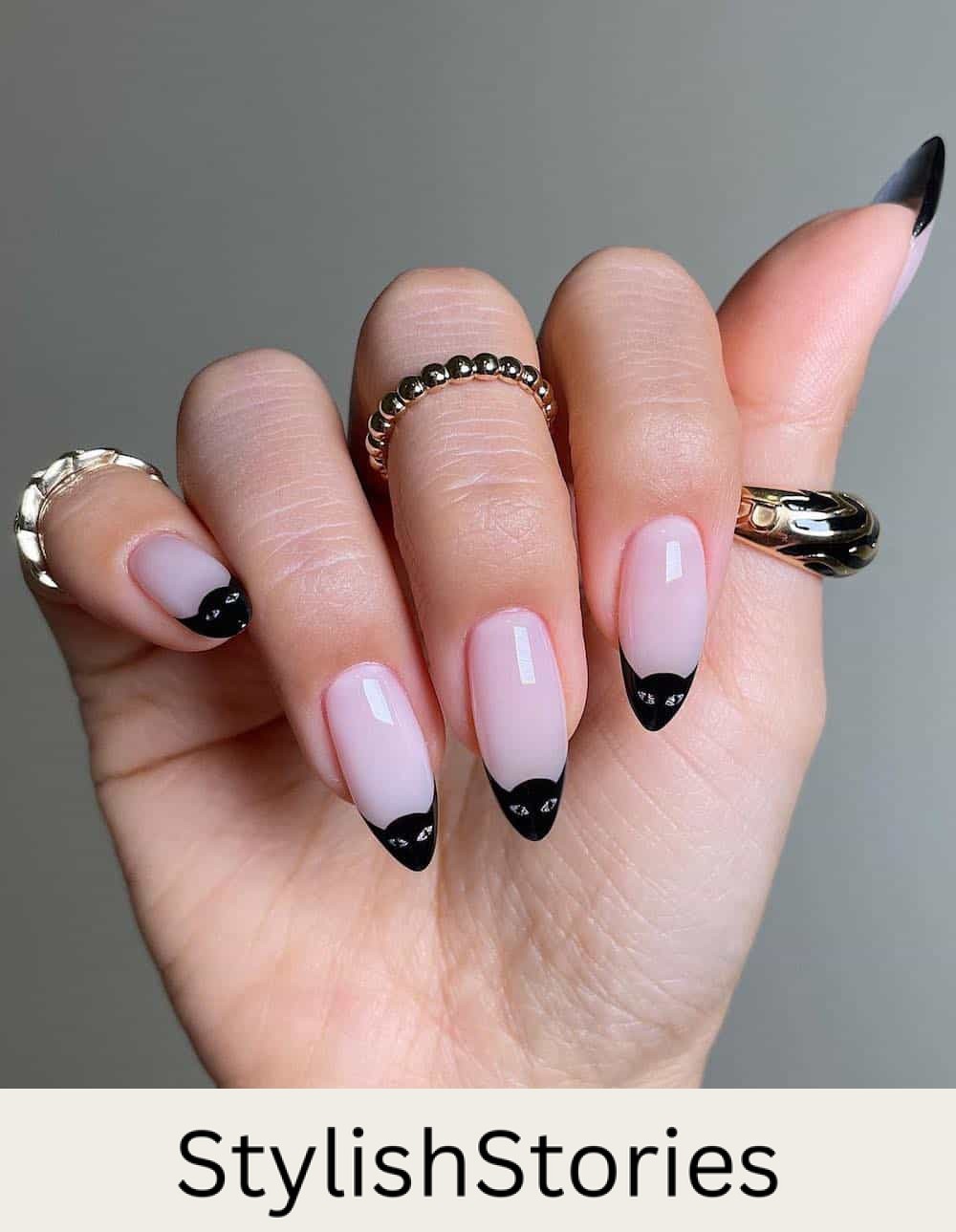 long nude pink almond nails with black cat tips