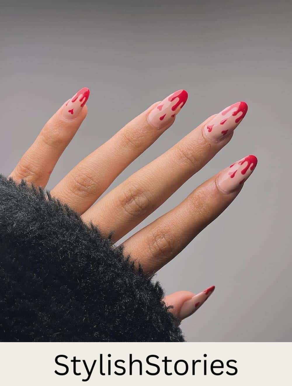 long nude almond nails with pink dripping tips and heart accents