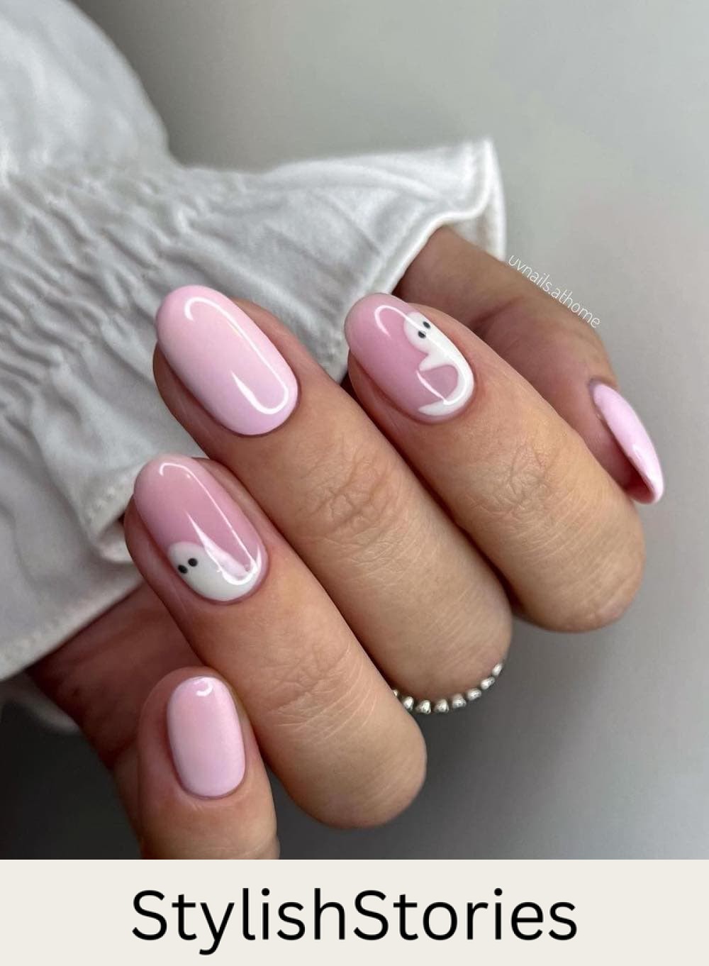 short pink round nails with white ghost nail art
