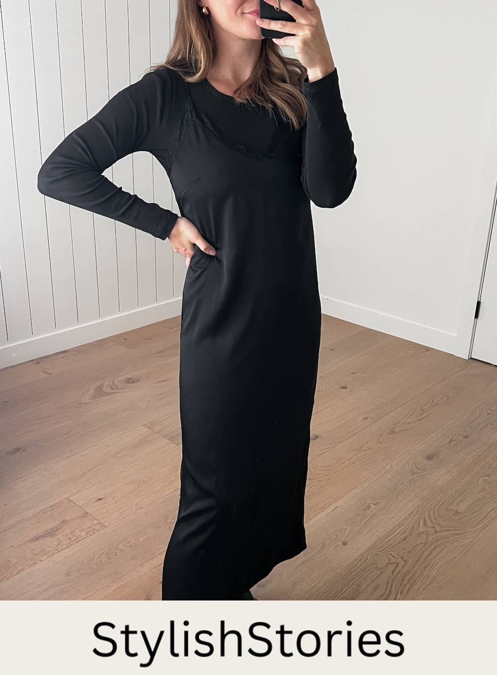 Christal wearing a black slip dress with a long sleeve tee under and black Chelsea boots.