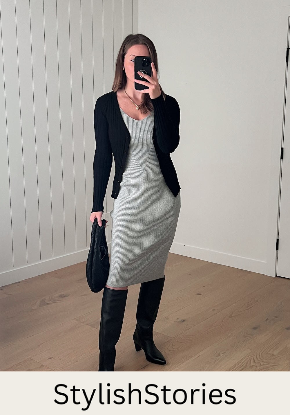 Christal wearing a grey sweater dress and a black cardigan with tall black boots.