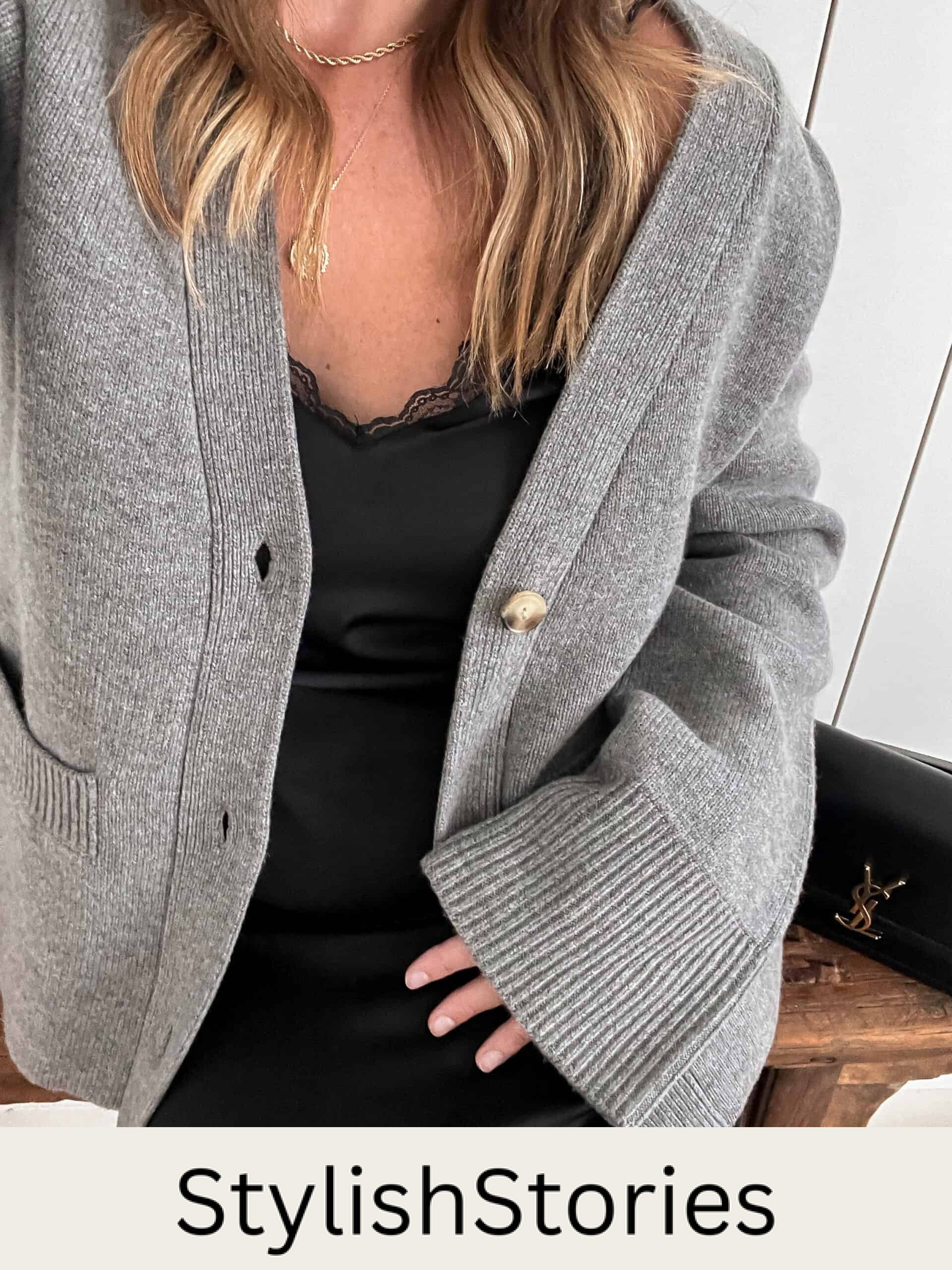 woman wearing a black slip dress under a thick knit grey cardigan