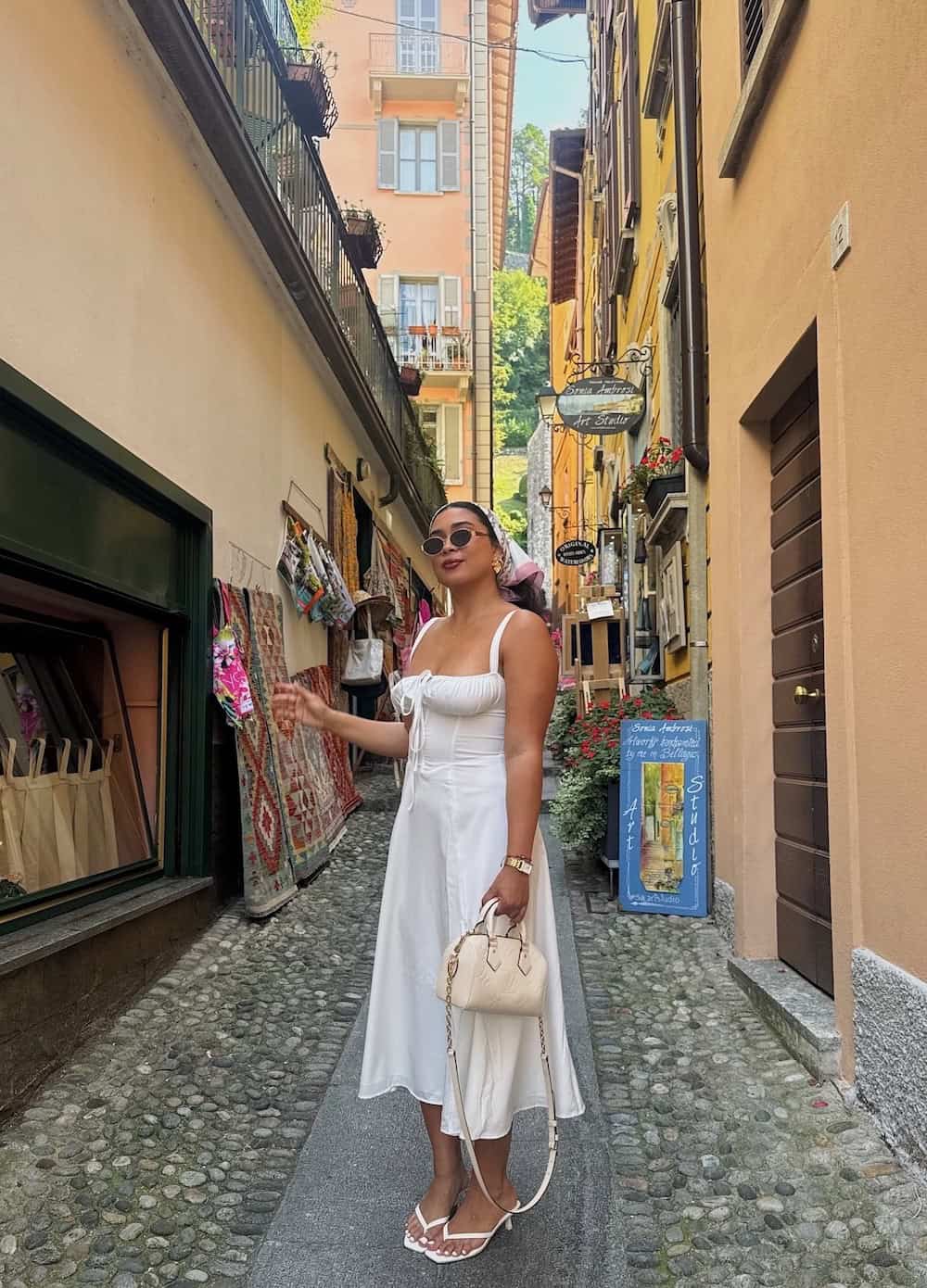 a woman wearing a white midi dress with low heeled sandals