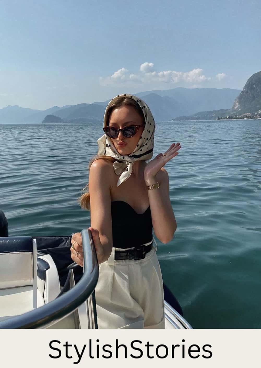 Woman wearing linen shorts, a black tube top and a polka dot scarf.