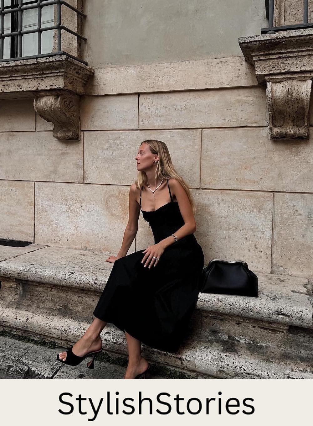 Woman wearing a black linen dress with black heels.