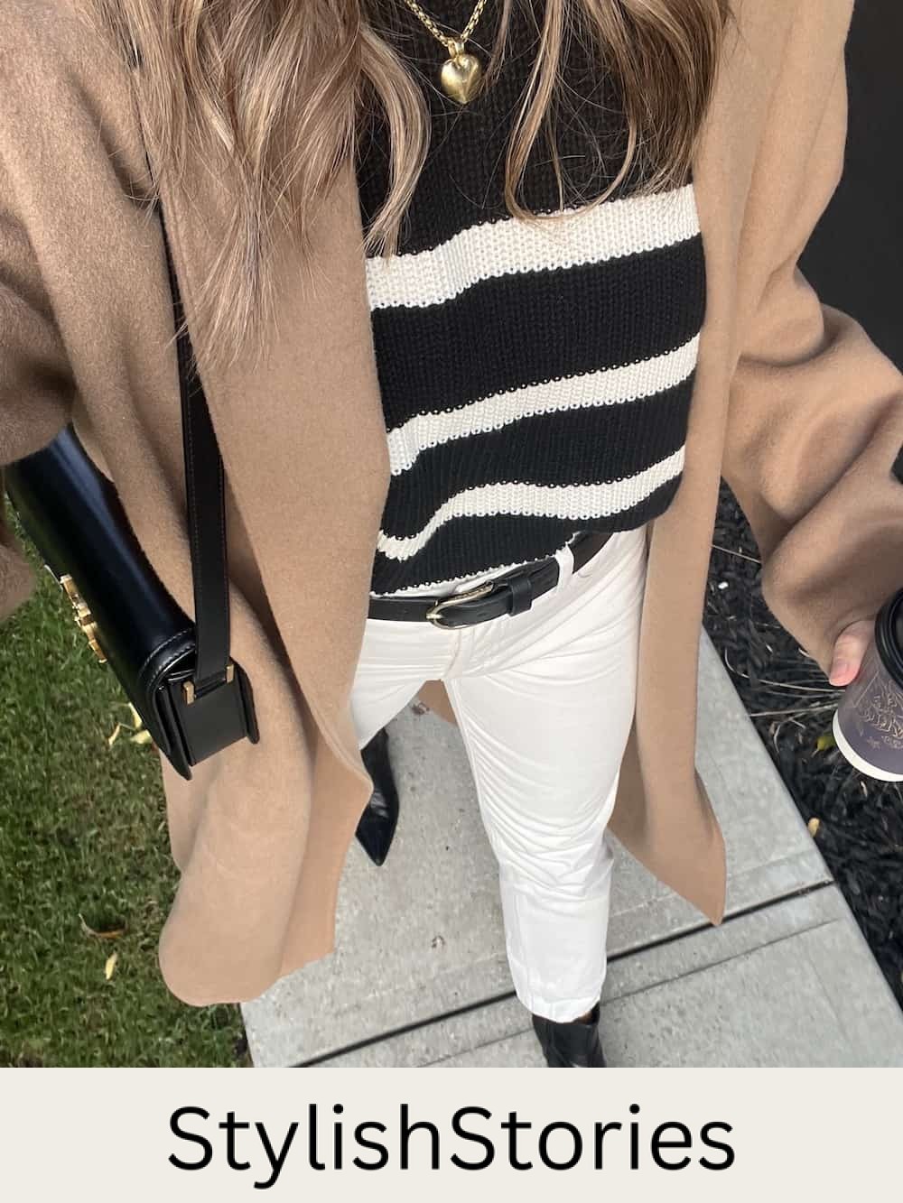 Christal wearing a camel Jenni Kayne cashmere overcoat with a striped black sweater and off-white jeans