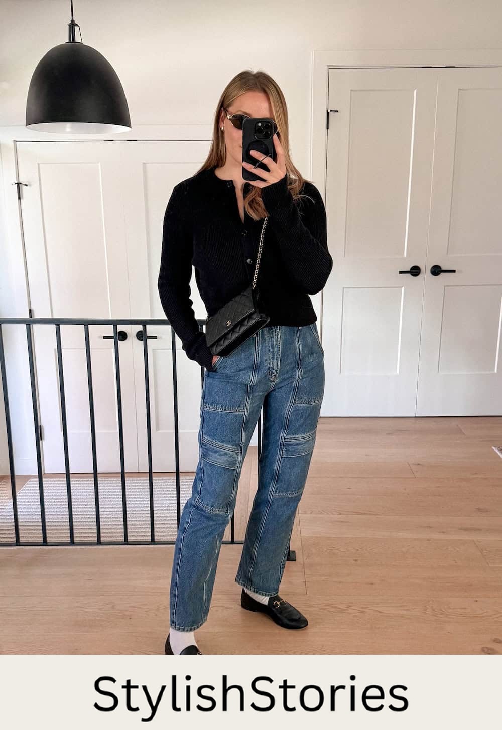 Christal wearing cargo jeans with a black cardigan and loafers.