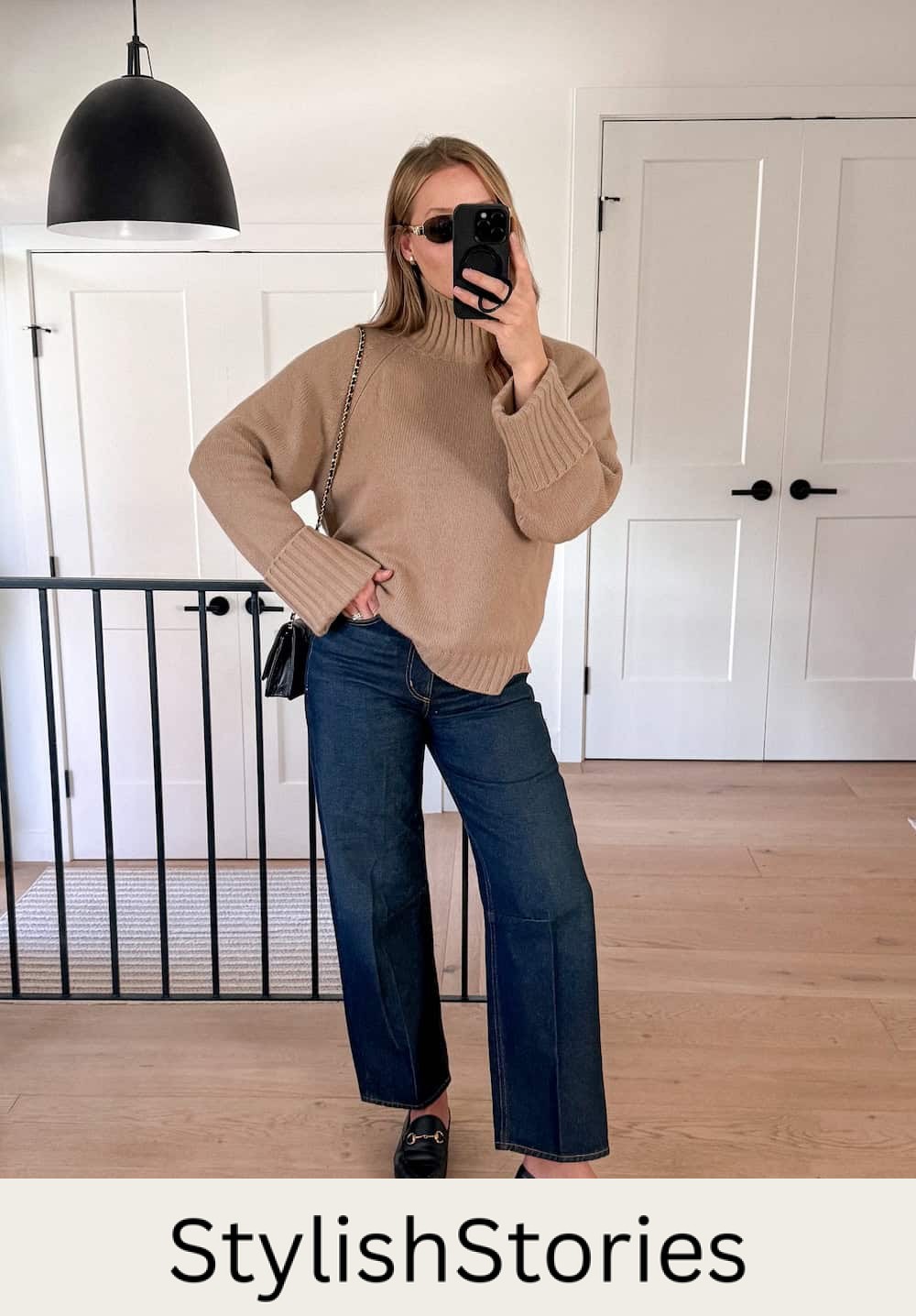 Christal wearing wide-leg jeans a turtleneck sweater and loafers.