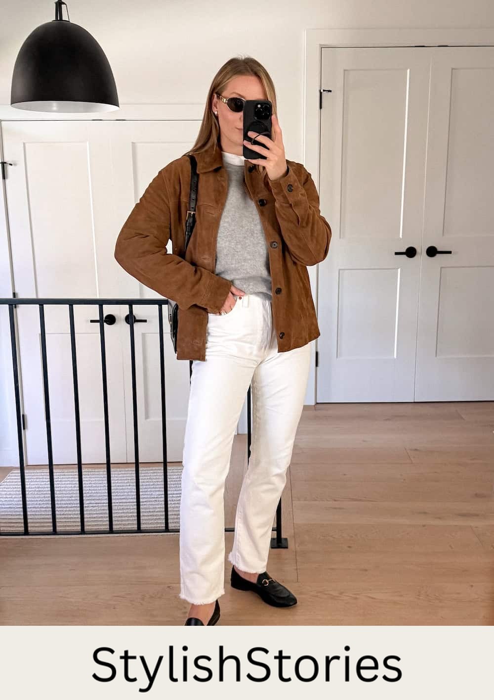 Christal wearing white jeans with a suede coat and loafers.