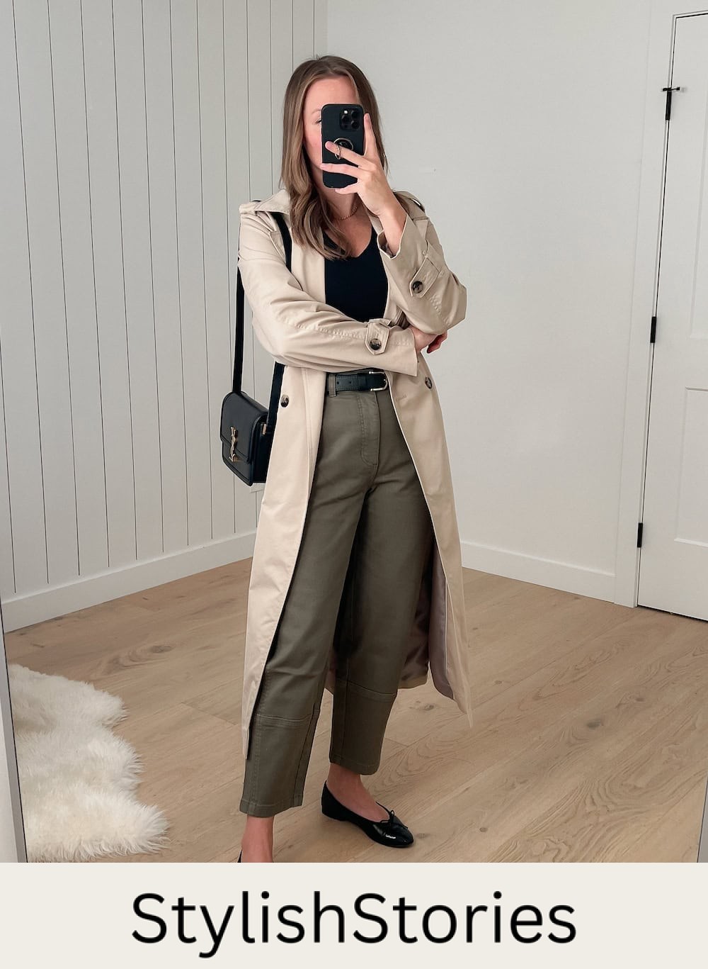 Christal wearing green pants, a black knit top and a long coat with ballet flats.