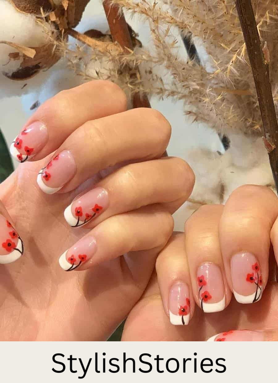 short nude squoval nails with white tips and red poppy nail art