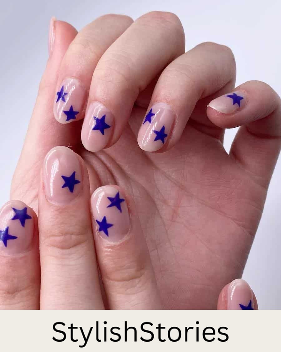 short round nude nails with bright blue stars