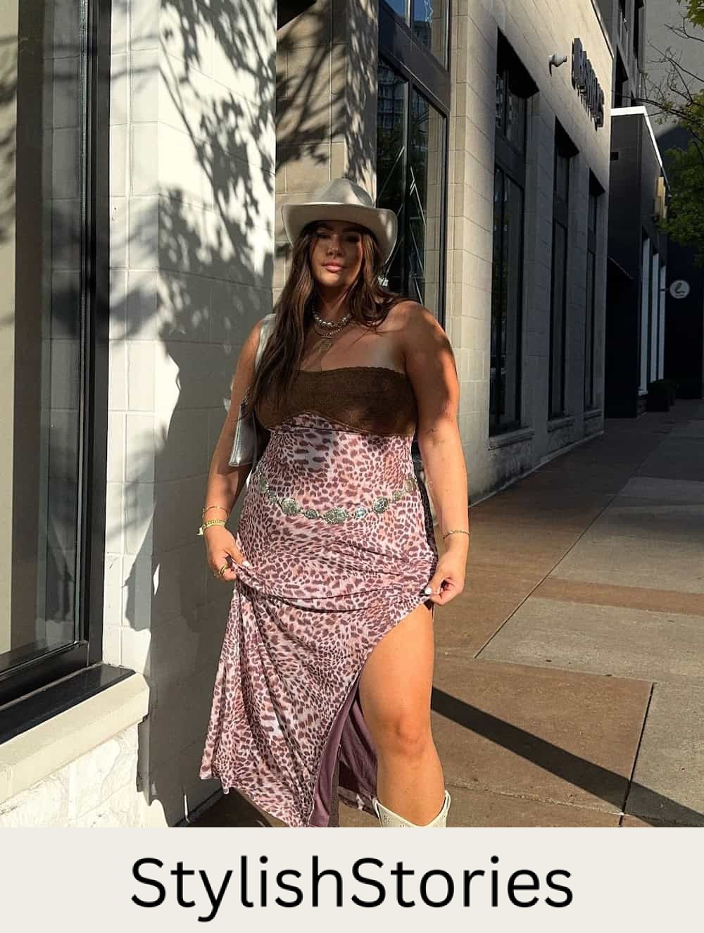 woman wearing a stylish country concert outfit with a leopard print dress, white cowboy boots and a straw cowboy hat