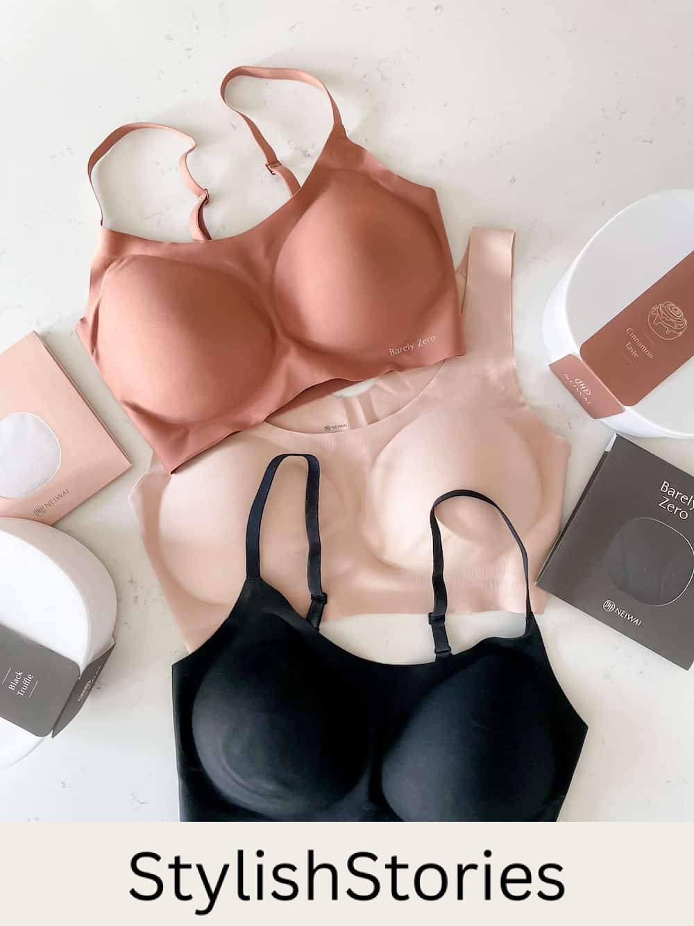 image of three NEIWAI Barely Zero bras on a marble surface in black, light pink, and dark nude pink
