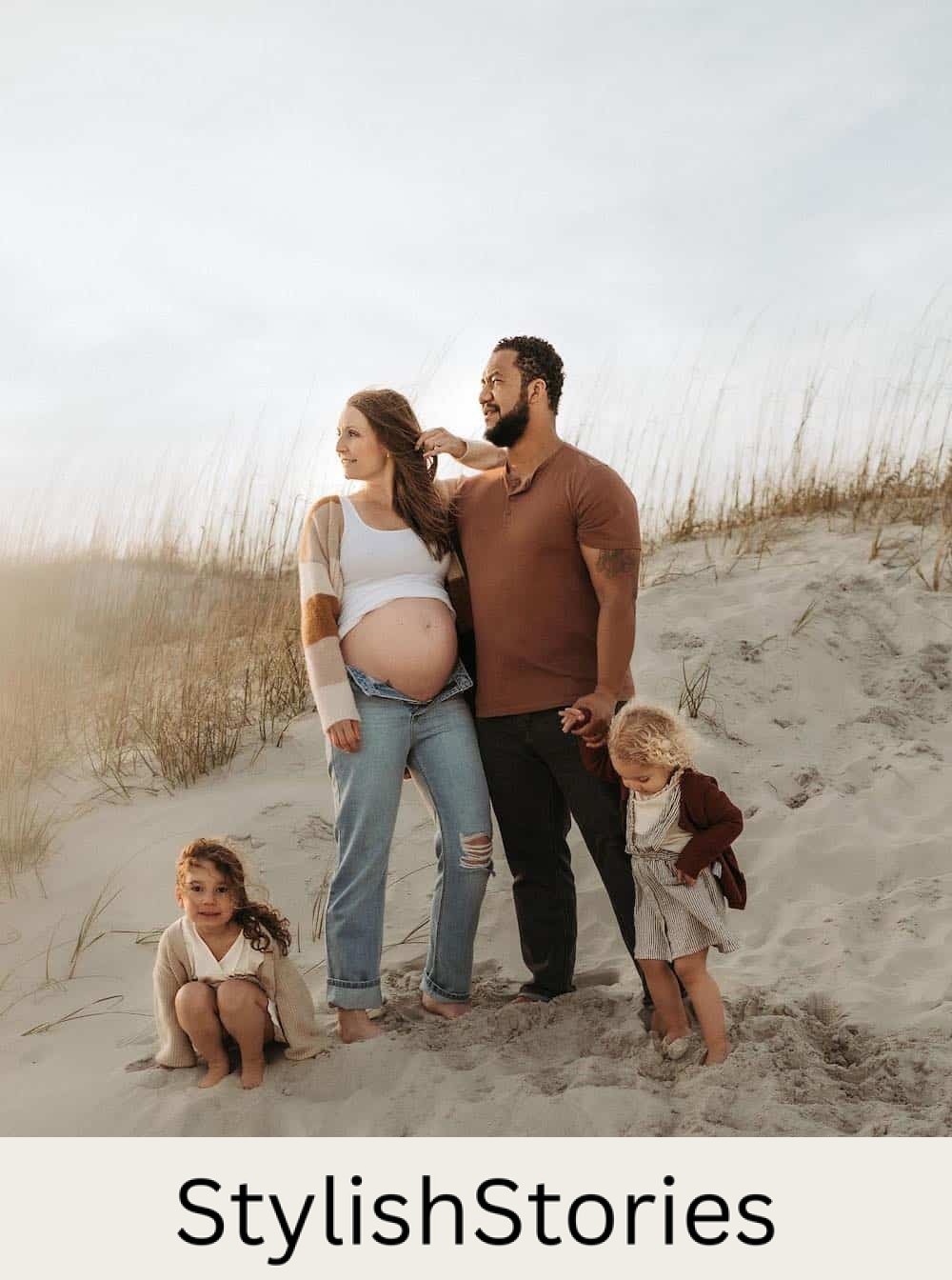 family on a beach for a photoshoot wearing netural colors including brown, white, and beige