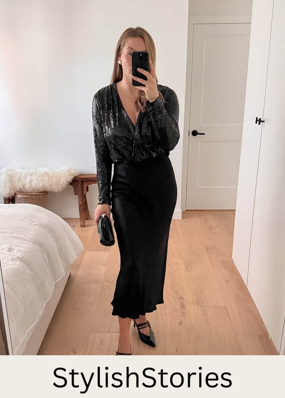 Woman wearing a black slip skirt with a black sequined bodysuit and pumps.