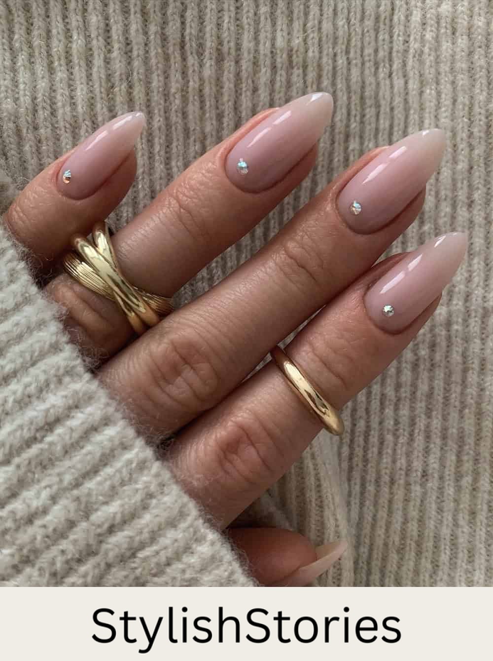 long milky pink almond nails with gem details