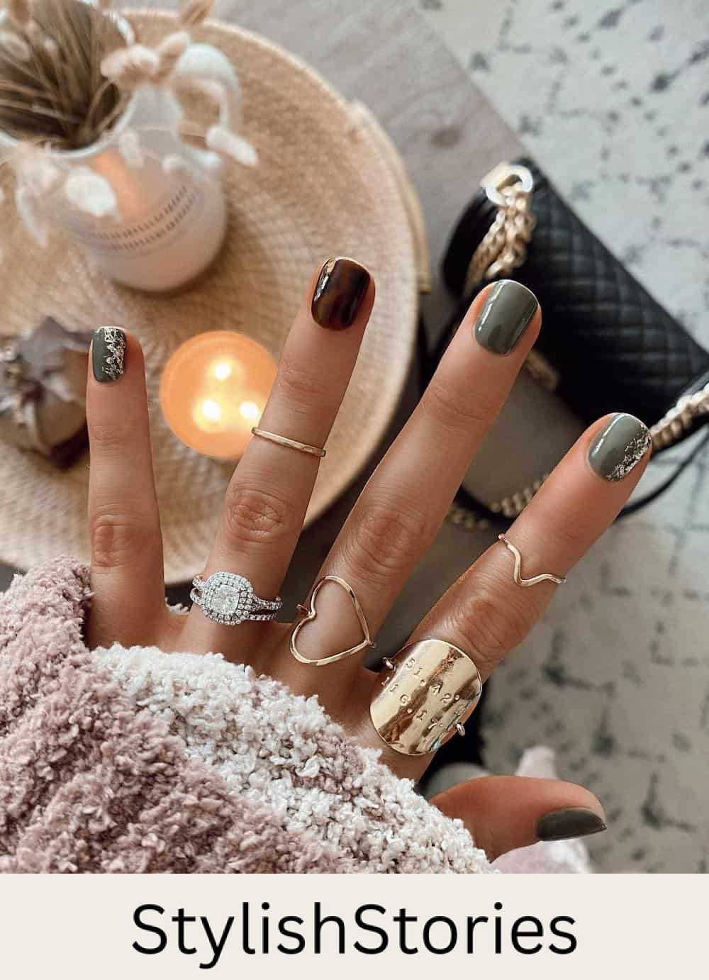 image of a hand with olive green and brown tortoiseshell nails with gold accents