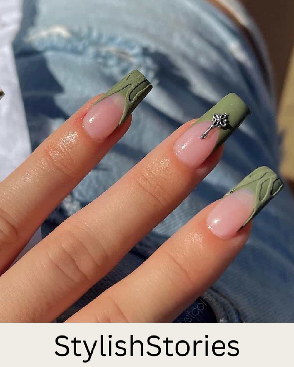 image of a hand with olive green nails with silver gem embellishments