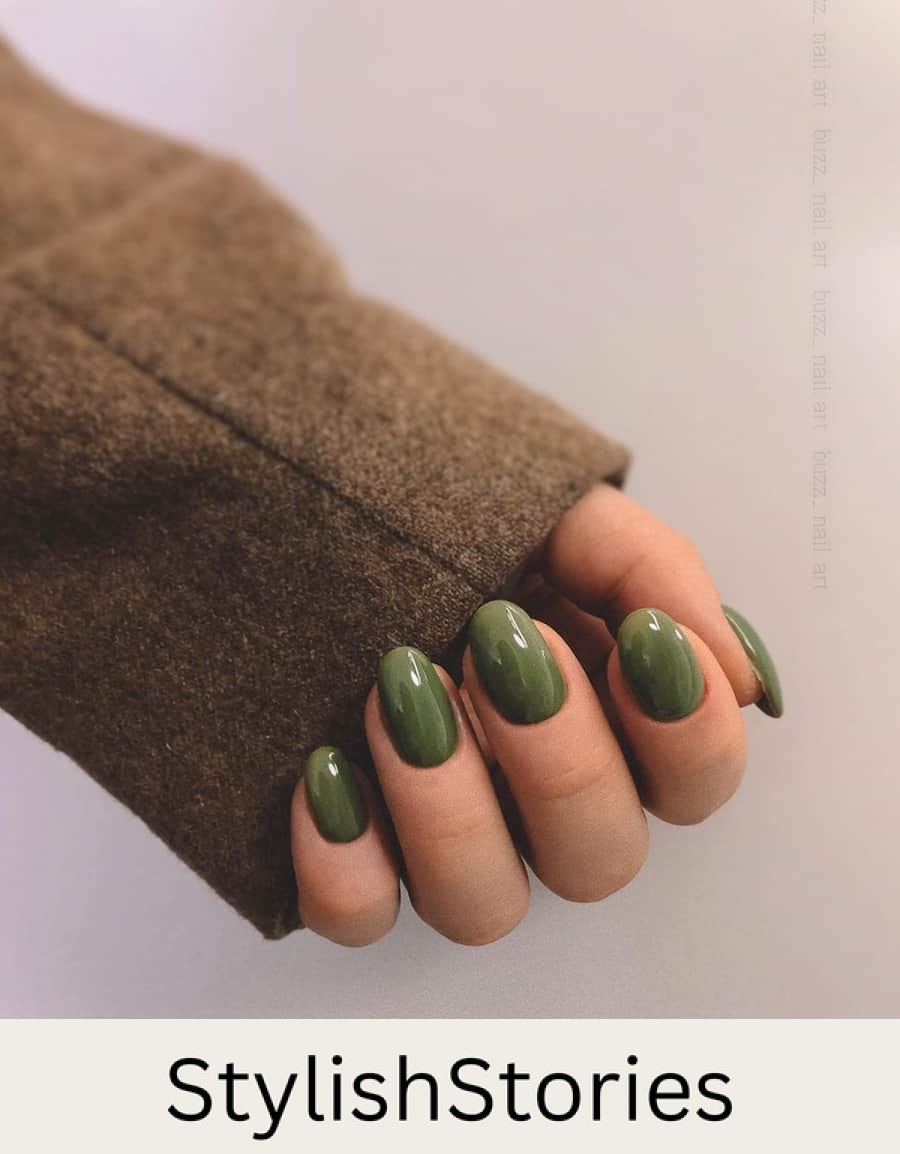 hand with rounded nails with dark olive green polish