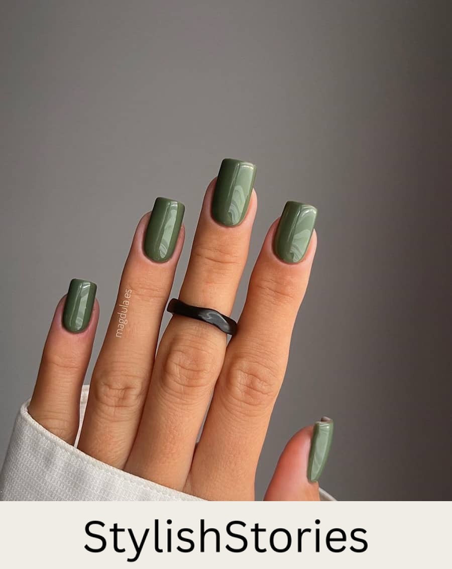 hand with square nails with olive green nail polish