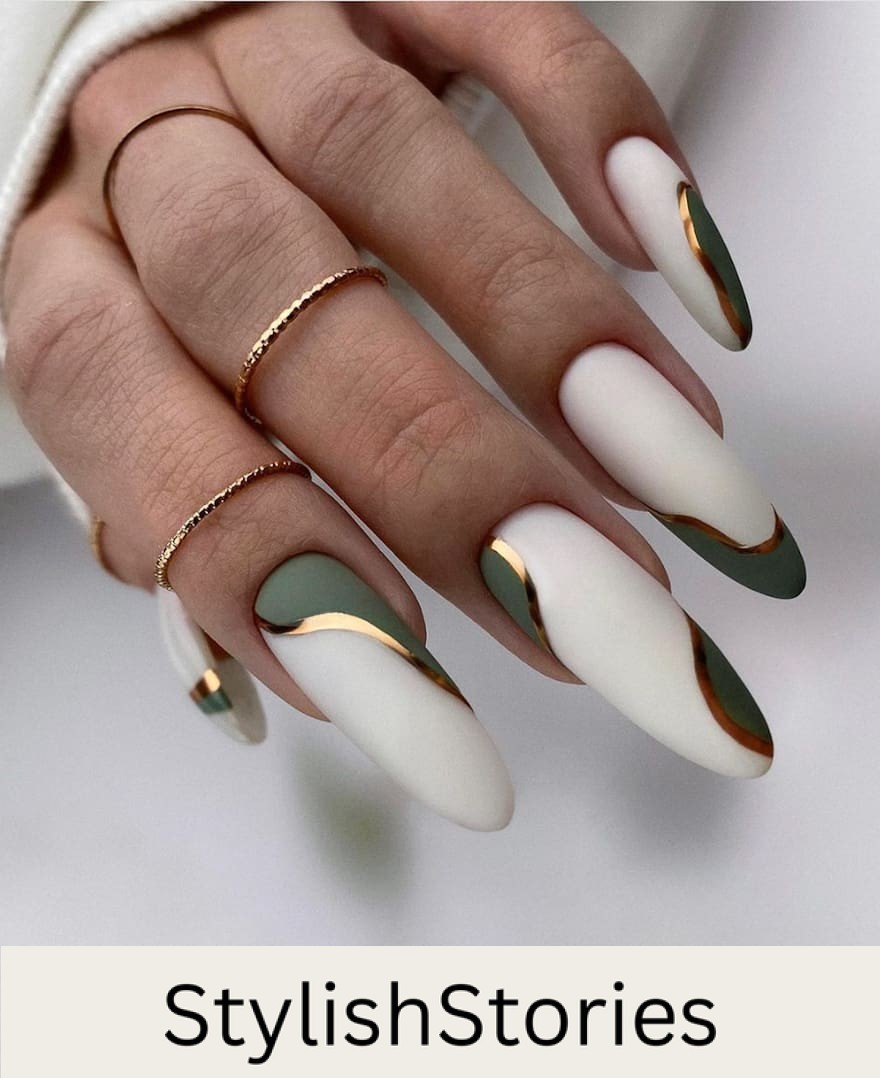 hand with long almond nails with white, gold, and olive accents