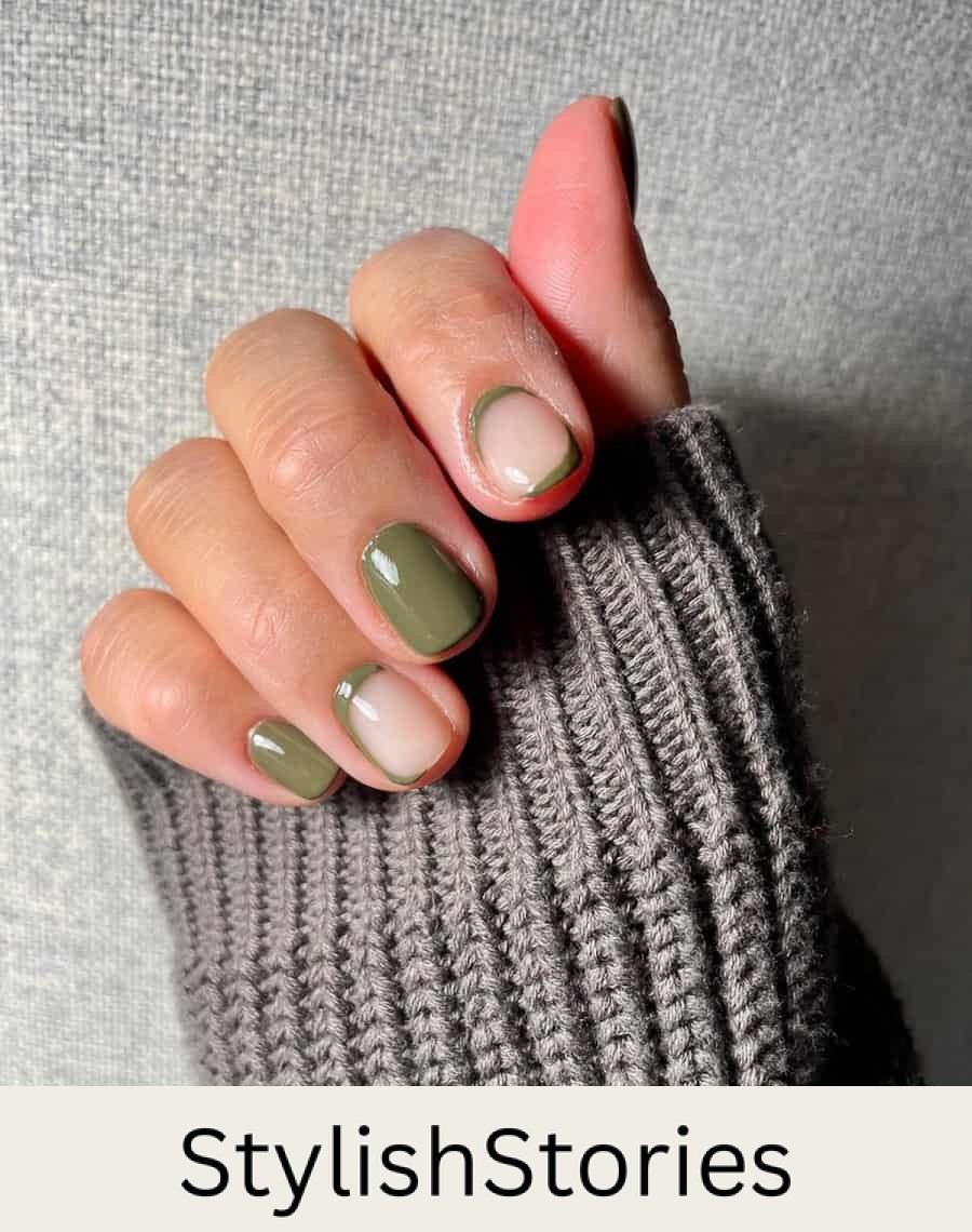 hand with short nails with olive green nail polish and neutral accents