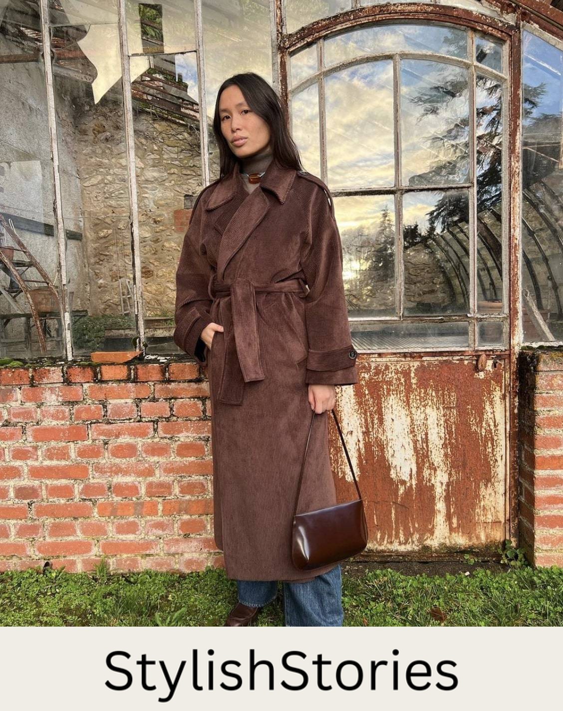 Parisian woman wearing a long brown wool coat with jeans and brown loafers