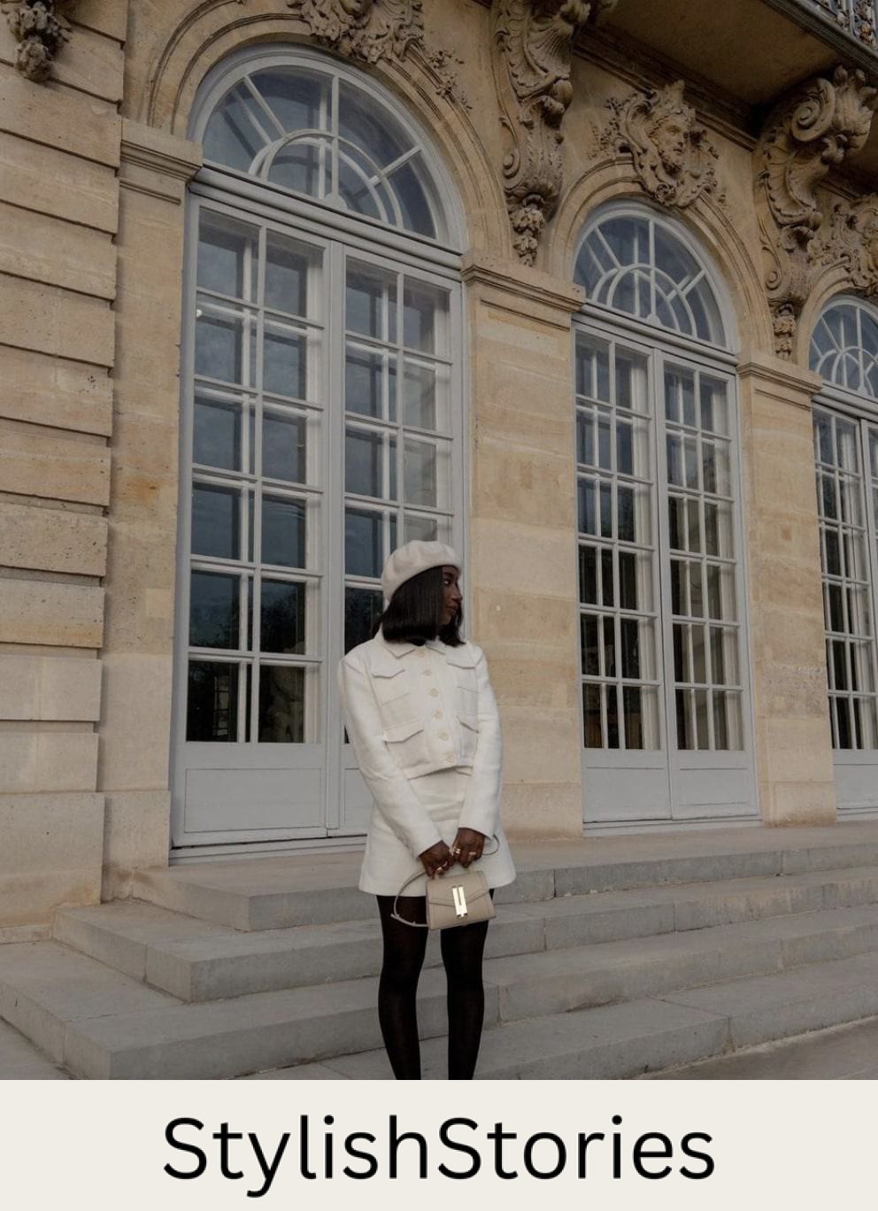black french woman wearing an ivory beret with an ivory tweed skirt set