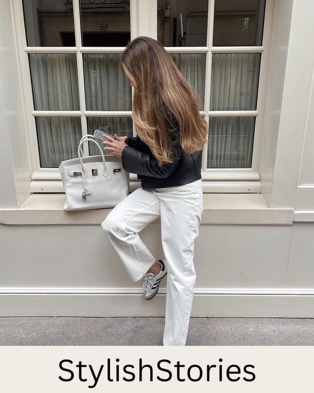 woman in Paris wearing a leather cropped jacket with off-white jeans and Adidas Samba sneakers