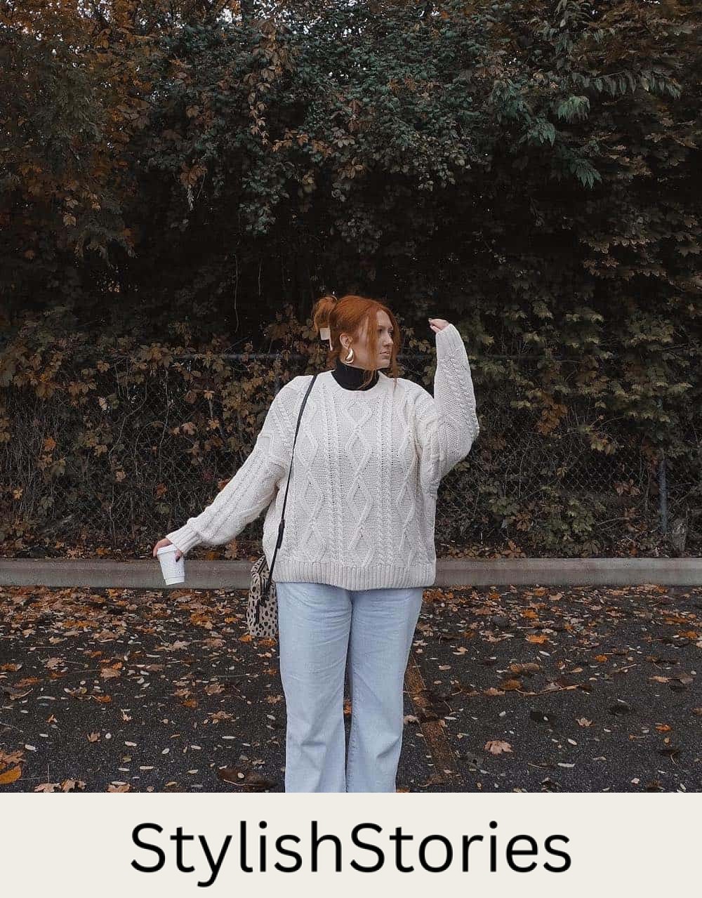 a woman wearing wide-leg light blue denim pants with a white knit sweater and black boots