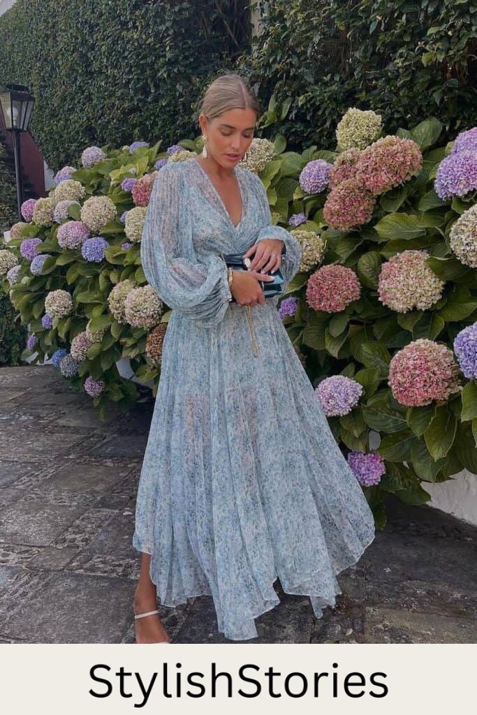 woman at a spring wedding wearing a blue floral long sleeve maxi gown