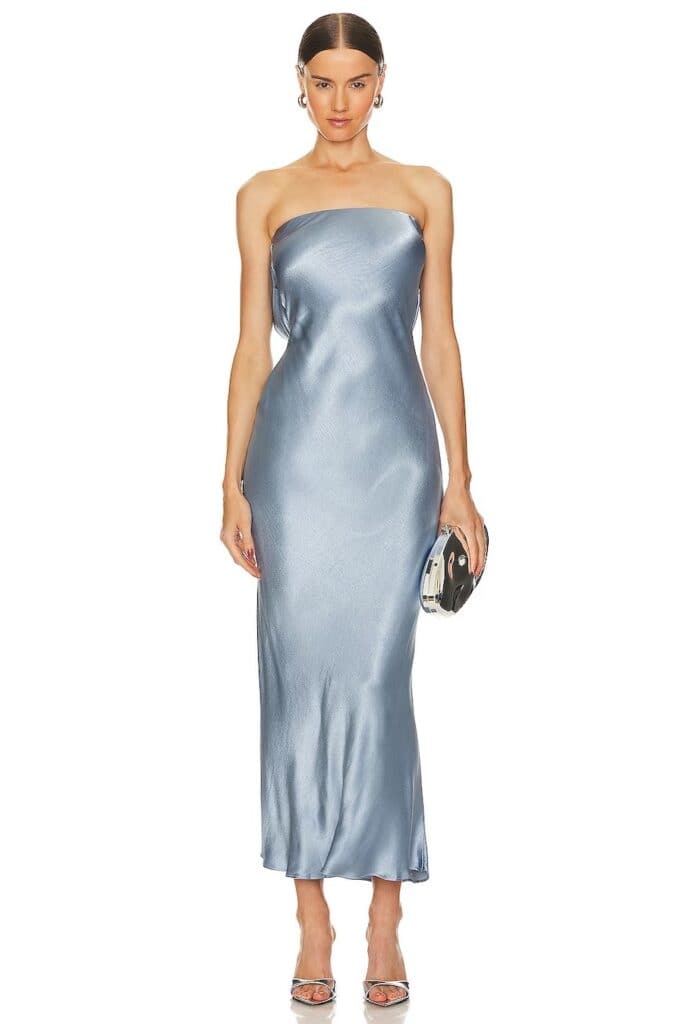 A woman wearing a dusty blue strapless satin midi dress