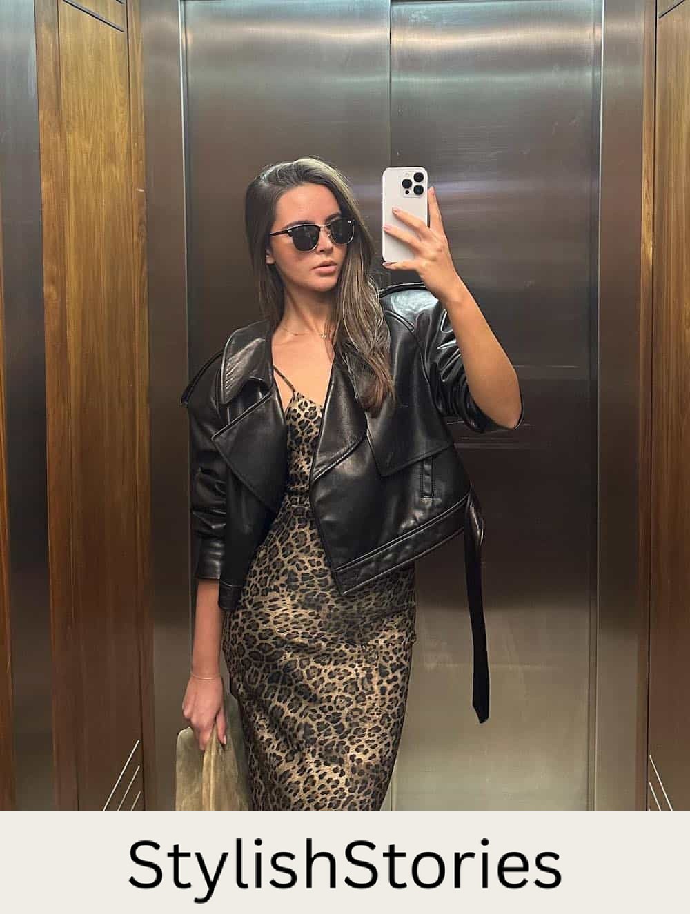 a woman wearing a cheetah print slip midi dress and a black leather jacket