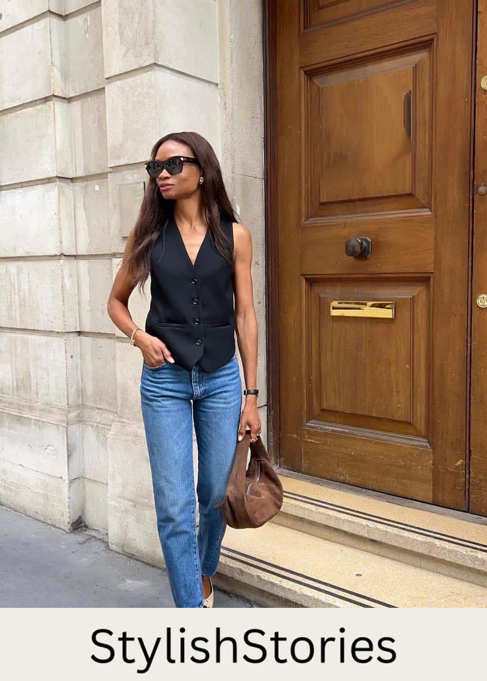Woman wearing straight jeans with a black vest top and ballet flats.