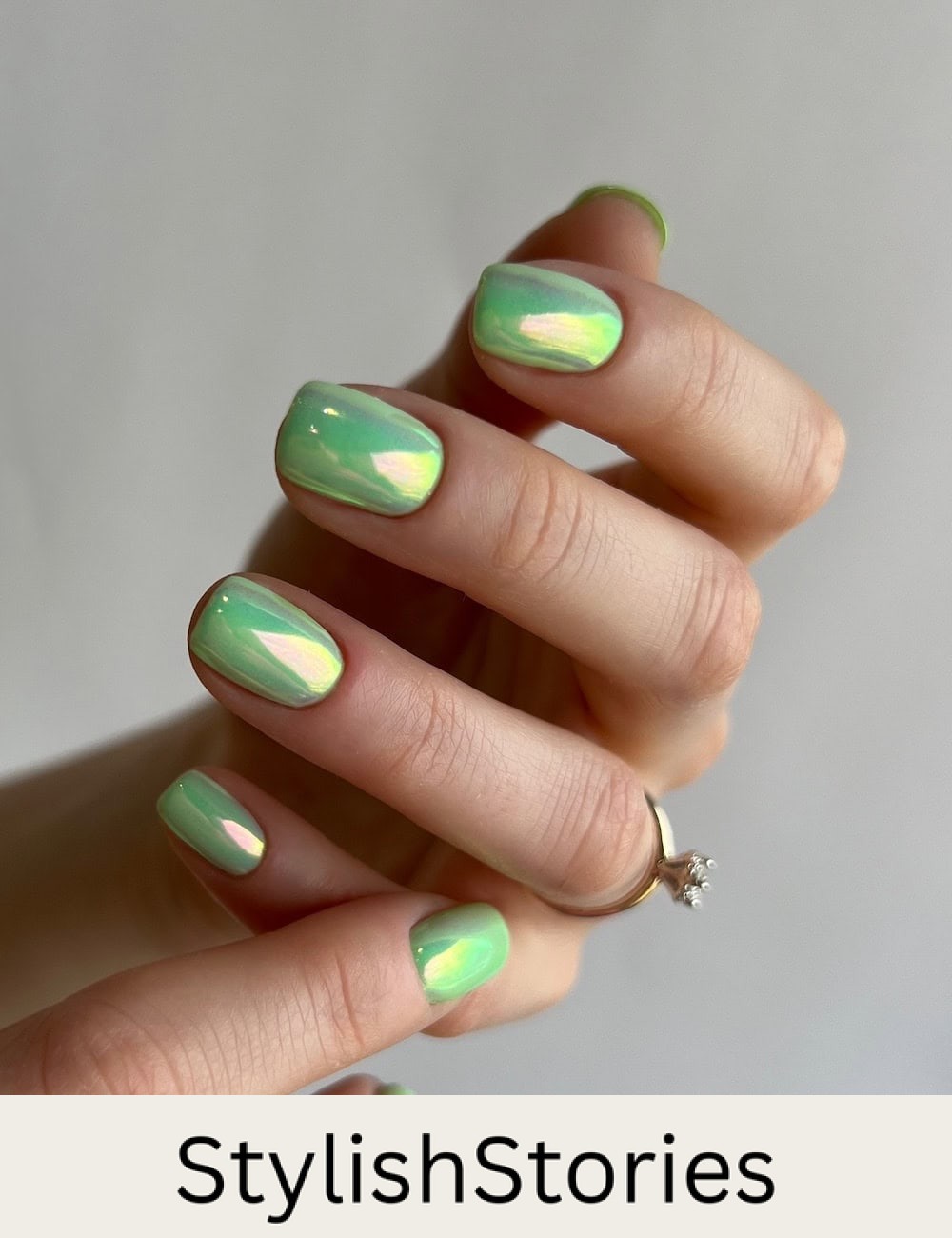 short squoval nails with a lime green polish and chrome finish