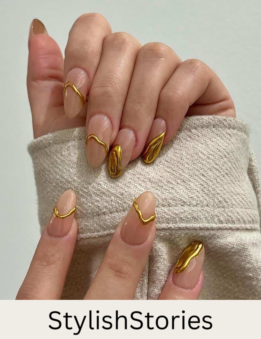 long nude almond nails with dripped gold french tips