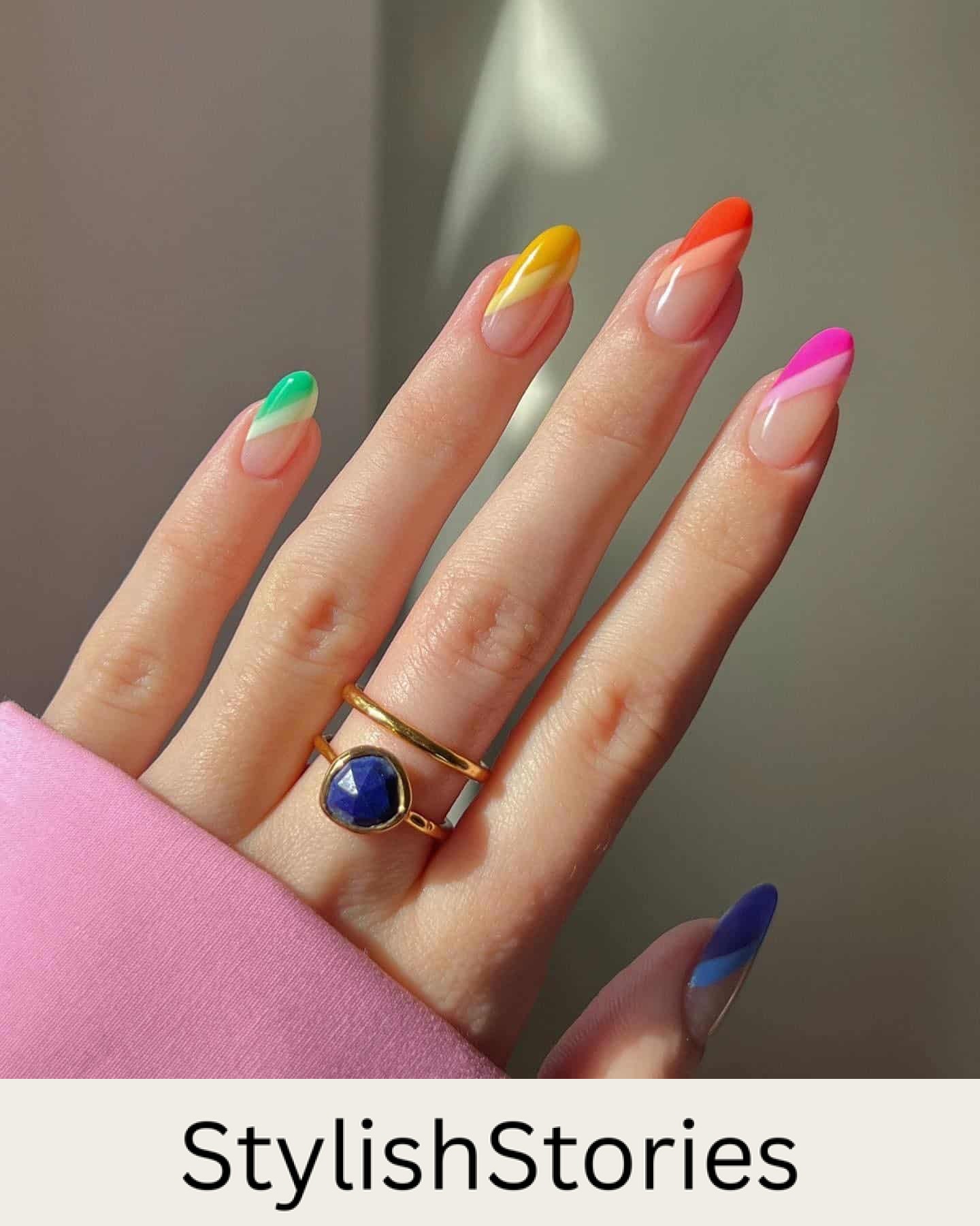 A hand with medium round nails painted with gradient asymmetrical French tips