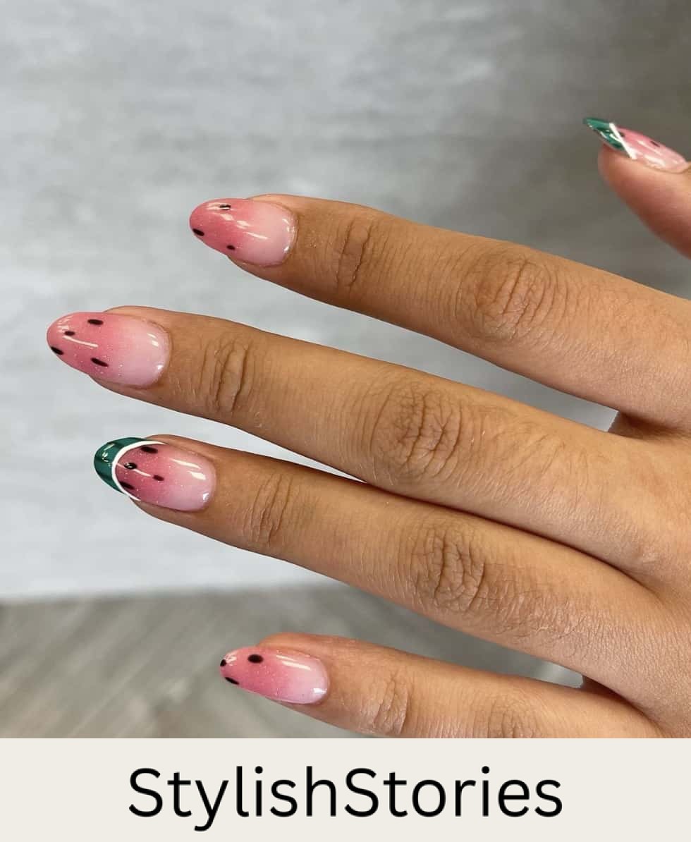 A hand with medium almond nails painted with a pink color with watermelon ombre tips and green rind French tips