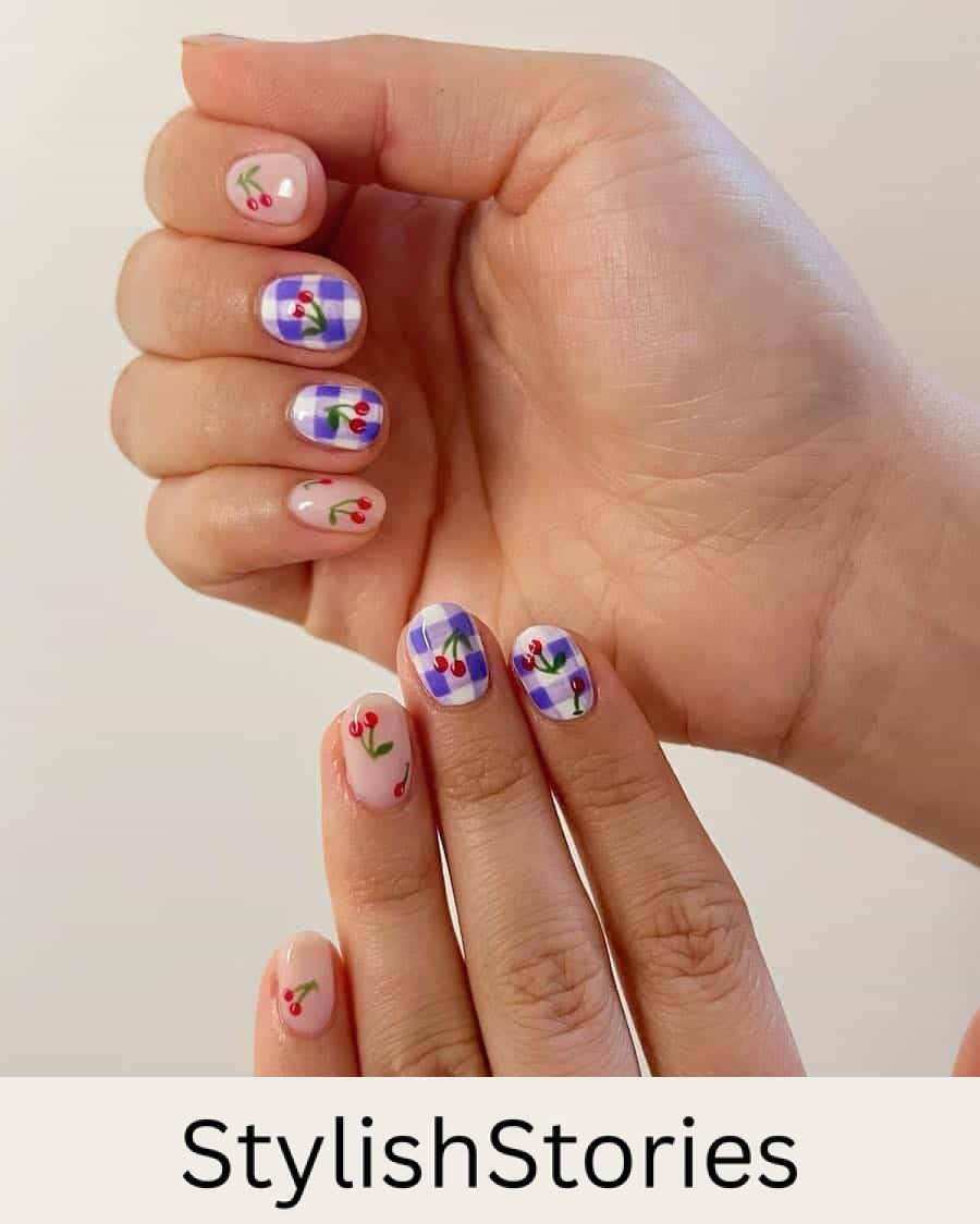 Short nude nails with cherry nail art and accent nails featuring purple gingham