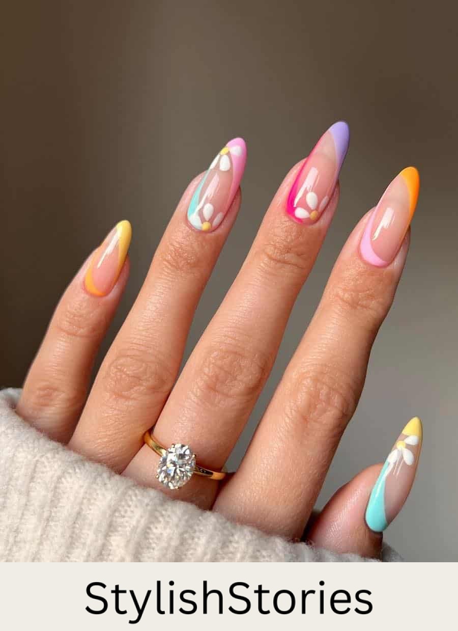 Long nude almond nails with colorful French tips and reverse French tips with floral nail art
