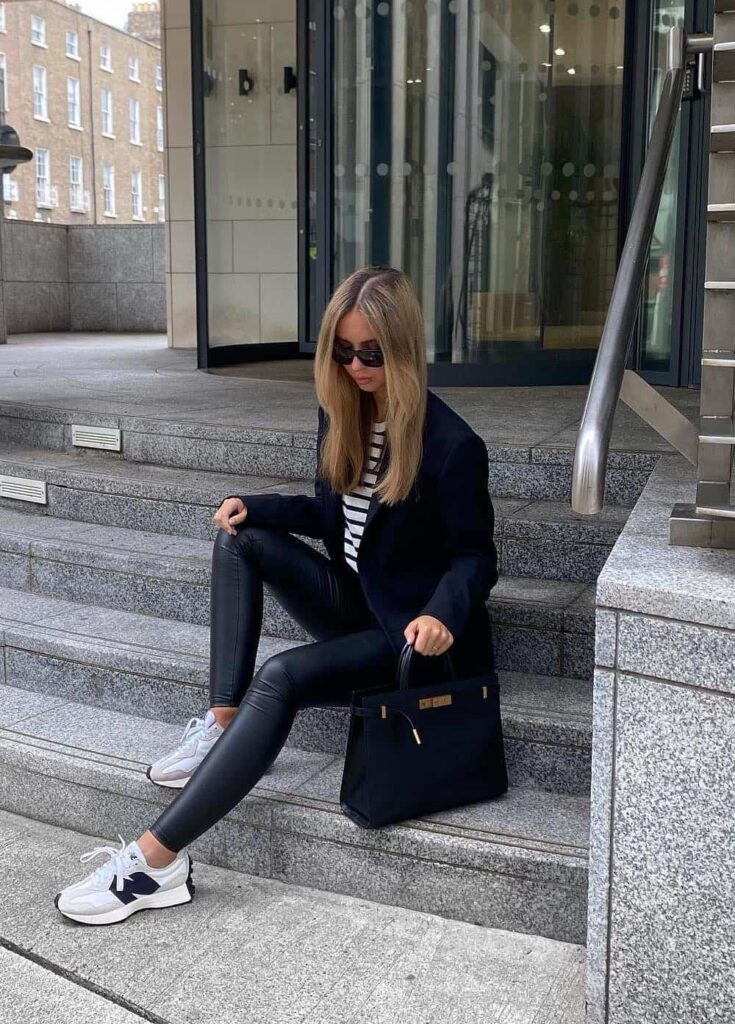 woman wearing a blazer with leather leggings and sneakers