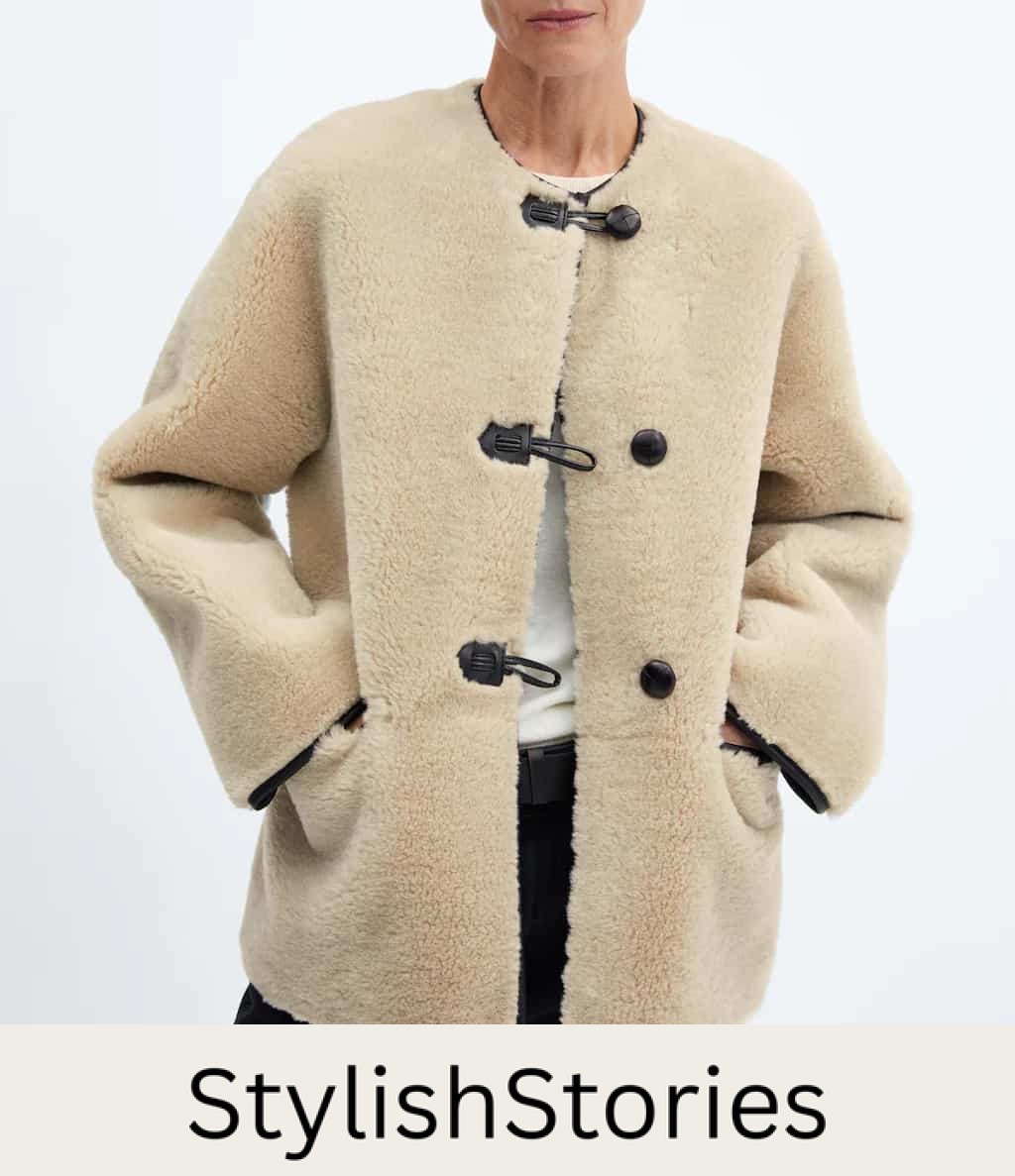 image of an ivory shearling coat with black buttons that is a dupe of the Toteme shearling coat