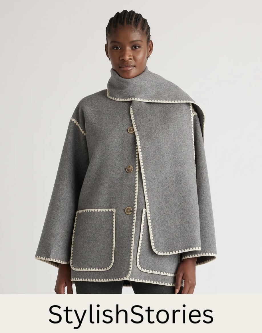 image of a woman wearing a grey wool scarf jacket with white contrast stitching details that is a dupe of the Toteme scarf jacket
