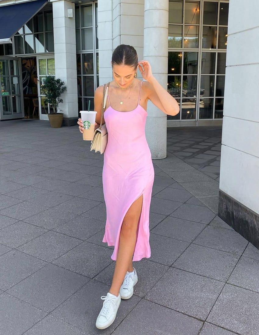 image of a woman in a bubble gum pink slip dress, white sneakers, for walking the strip in Vegas