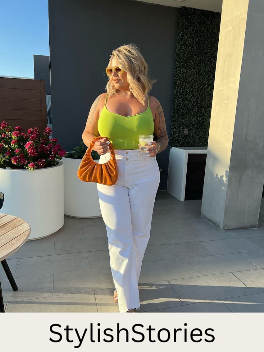 image of a plus size woman wearing a green tank top and white wide leg jeans with heels in Vegas