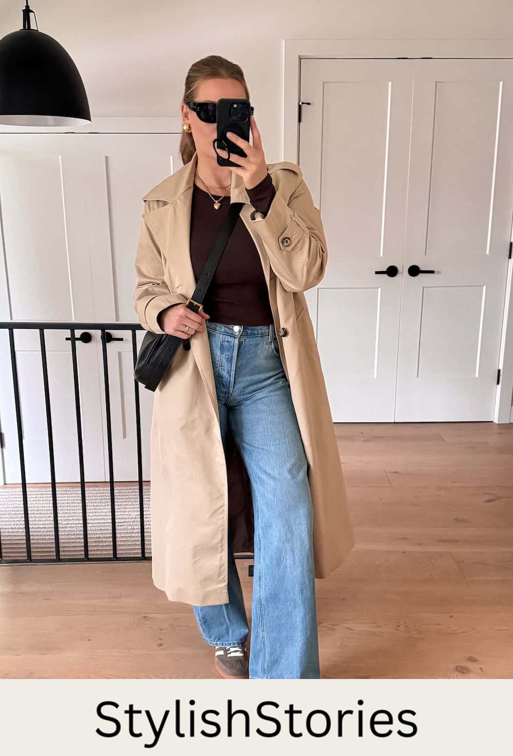 Christal wearing light wash wide leg jeans with sneakers and a trench coat.