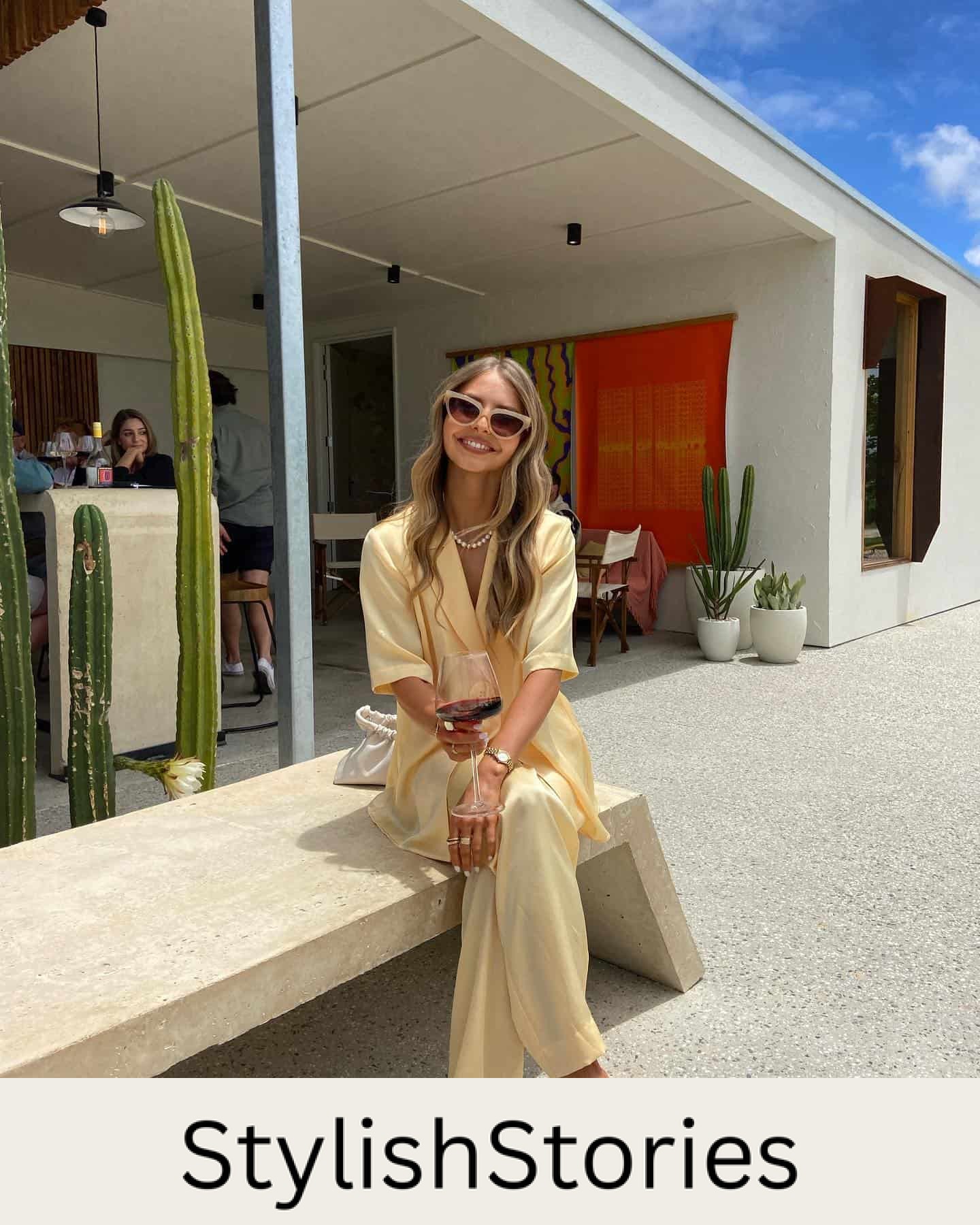 woman wearing a butter yellow silk pant set at a winery